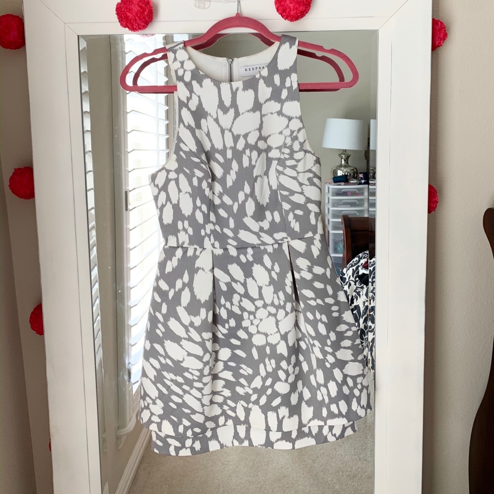Gray cocktail dress with long peplum skirt.